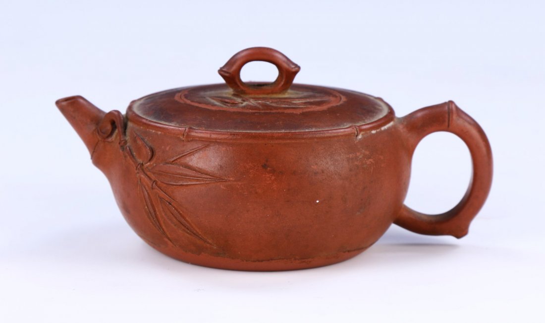A Chinese Antique Zisha Teapot: A Chinese Antique Zisha Teapot: Of Compressed Globular Form, Bamboo Stalks Finely Embossed Next To The Spout And Onto The Lid; Size: L: 4-3/4" (12.07cm)