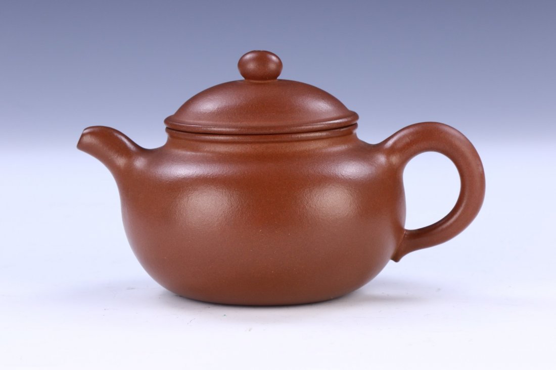 A Chinese Yixing Zisha Teapot: A Chinese Yixing Zisha Teapot: Of Compressed Globular Form; Size: L: 6-1/2" (16.51cm)