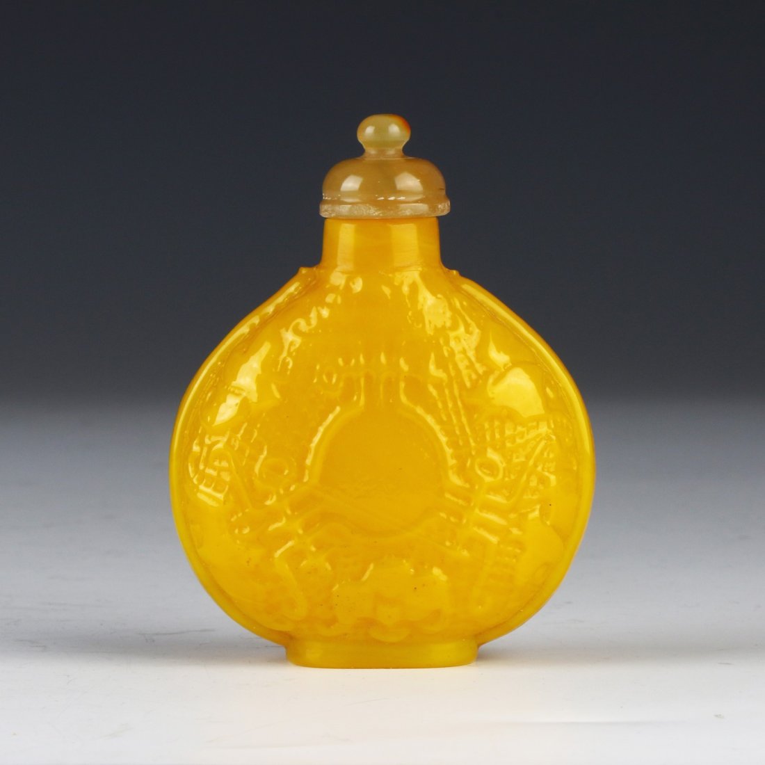 A CHINESE ANTIQUE YELLOW PEKING GLASS SNUFF BOTTLE: A Chinese Antique Yellow Peking Glass Snuff Bottle; Size: H: 3" (7.62cm)