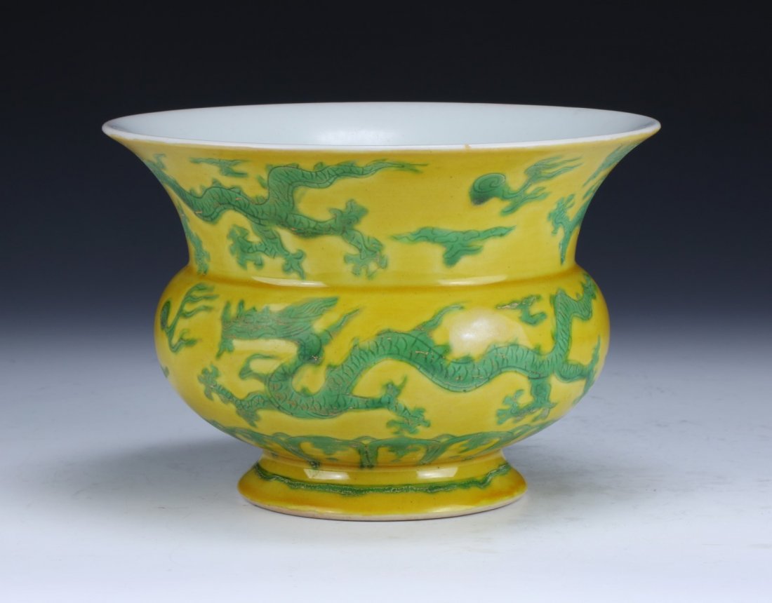 A Chinese Antique Yellow & Green Glazed Dragon Vase: A Chinese Antique Yellow & Green Glazed Dragon Vase: of compressed globular form, extending into a wide and outwardly flared rim, finely decorated throughout with sprawling dragons, with a four-charac