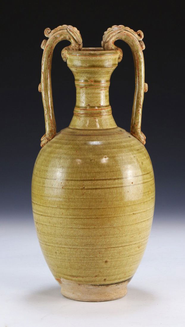 A CHINESE ANTIQUE CELADON GLAZED PORCELAIN VASE: A Chinese Antique Celadon Glazed Porcelain Vase: Of Ovoid Form, Cylindrical Neck Flanked On Each Side By A High Arching Dragon Form Handle, Ending in An Outwardly Flared Rim, Body With A Crackle Glaze