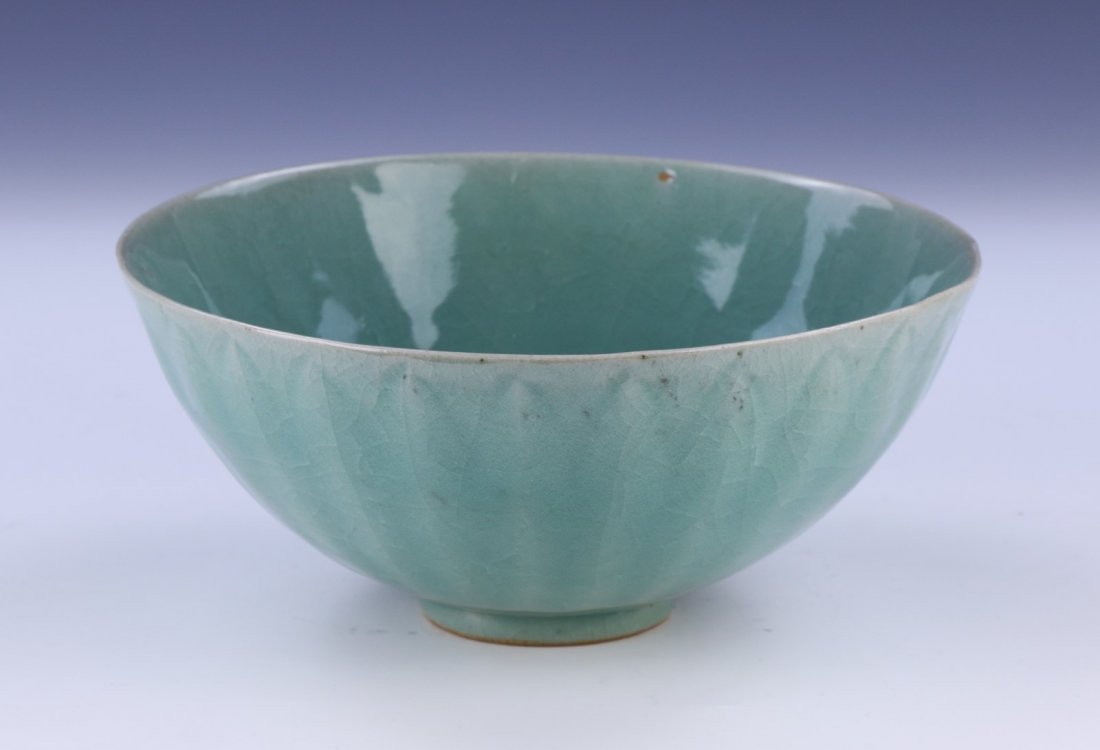 A CHINESE ANTIQUE CELADON GLAZED PORCELAIN BOWL: A Chinese Antique Celadon Glazed Porcelain Bowl: Evenly Glazed Throughout, With A Crackle Design And A Ridged Finish; Size: D: 8" (20.32cm)