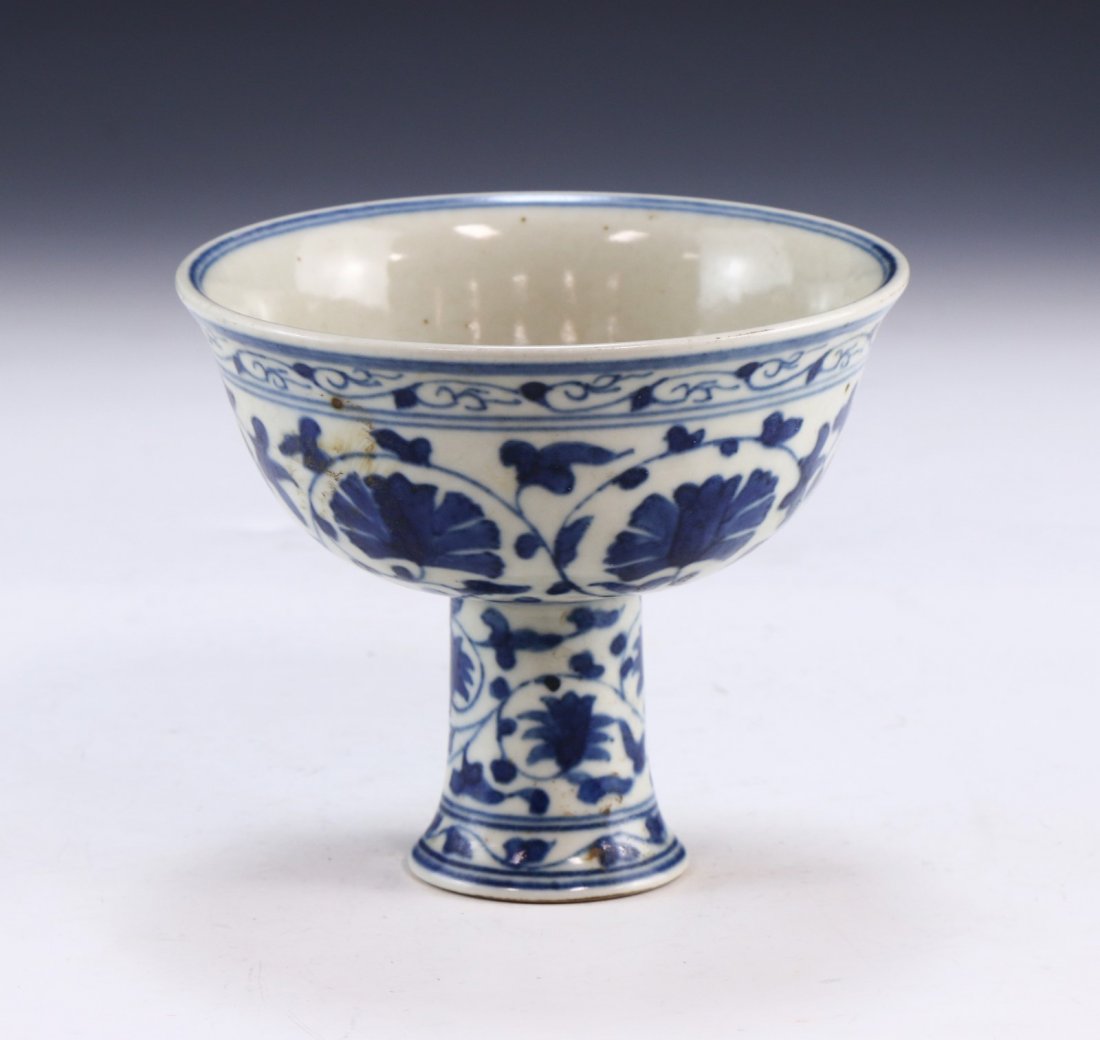 A CHINESE ANTIQUE BLUE & WHITE PORCELAIN STEM BOWL: A Chinese Antique Blue & White Porcelain Stem Bowl: Of Rising Sides, Cylindrical Stem And Exterior Body Finely Painted With Blooming Flowers Amid Continuous Stems And Vines, Six Character Mark Within