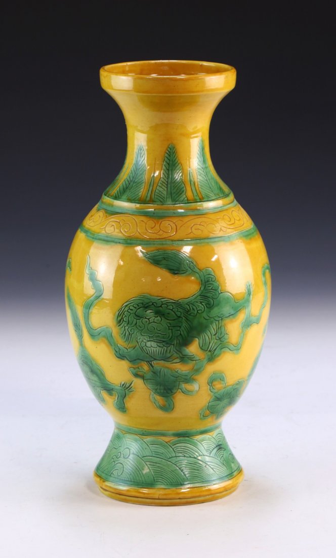 A CHINESE ANTIQUE YELLOW & GREEN GLAZED PORCELAIN VASE: A Chinese Antique Yellow & Green Glazed Porcelain Vase: Of Oval Form, Finely Painted With Green Lion Dog Figures Set Against An Even Yellow Glaze, Six Character Qianlong Mark On The Base in Deep Cobal