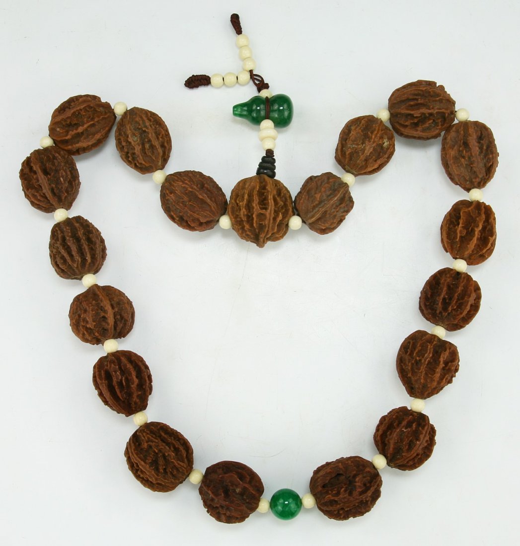 A CHINESE ANTIQUE SCHOLAR WALNUT NECKLACE: A Chinese Antique Scholar Walnut Necklace: Comprised Of Nineteen (19) Walnuts With Each Measuring Approximately 28mm in Length; Size: L: 24" (60.96cm); Walnut L: 28mm [Each]