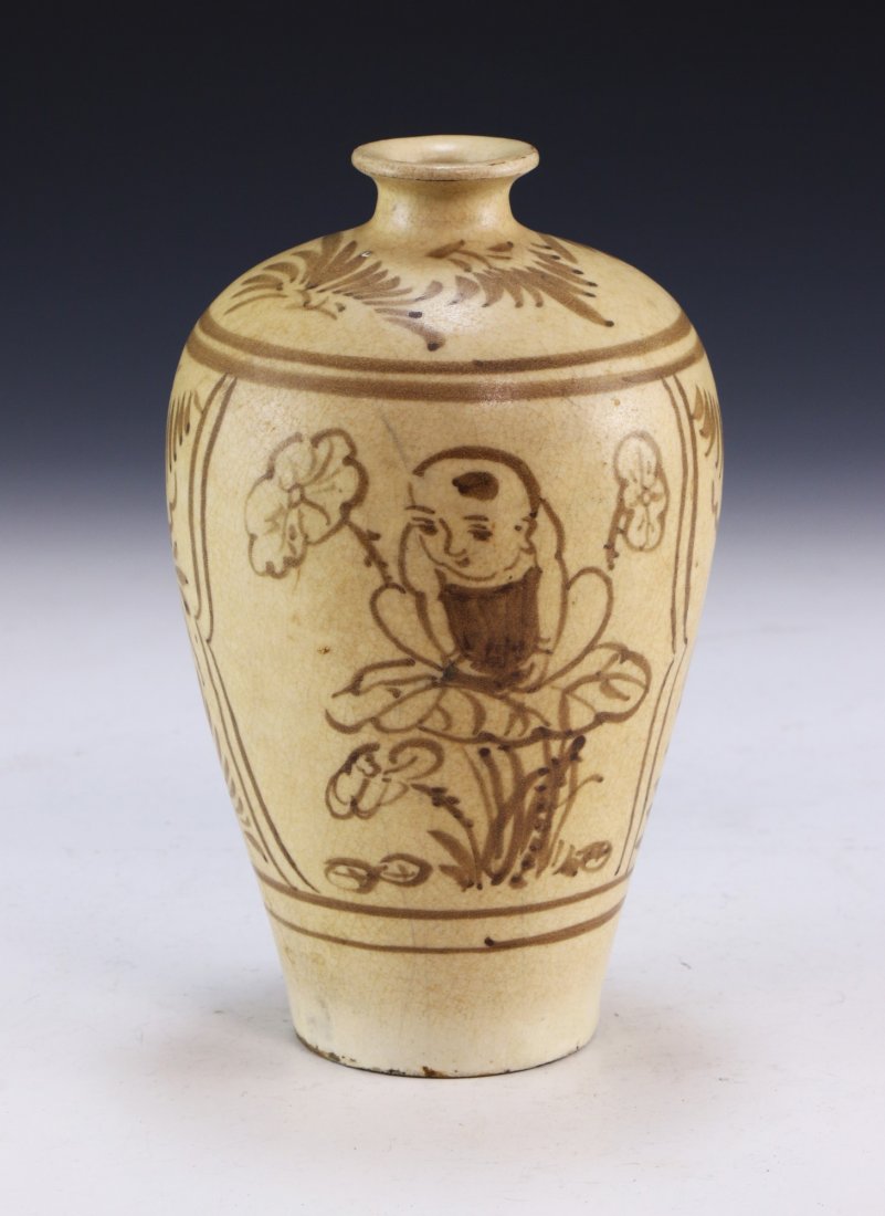 A CHINESE ANTIQUE INCISED CIZHOU YAO PORCELAIN VASE: A Chinese Antique incised Cizhou Yao Porcelain Vase: Of Shouldered Form, Finely Painted On Each Side With A Small Child At Rest On A Lily Pad Amid A Field Of Blooming Flowers; Size: H: 7-1/2" (19.05cm