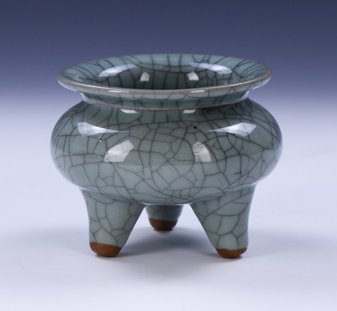 A CHINESE ANTIQUE GUAN-STYLE TRI-POD PORCELAIN CENSER: A Chinese Antique Guan-Style Tri-Pod Porcelain Censer: Thickly Potted, The Compressed Globular Body Supported On Three Feet, With Short Wide Neck Rising To Broadly Flared Mouth, Applied Overall With A