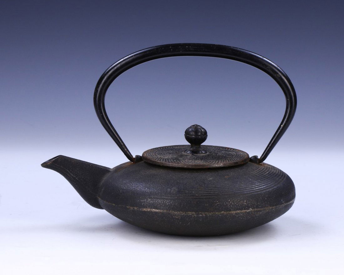 A JAPANESE ANTIQUE IRON TEAPOT: A Japanese Antique Iron Teapot: Of 19Th Century; Size: L: 9-1/4" (23.5cm)
