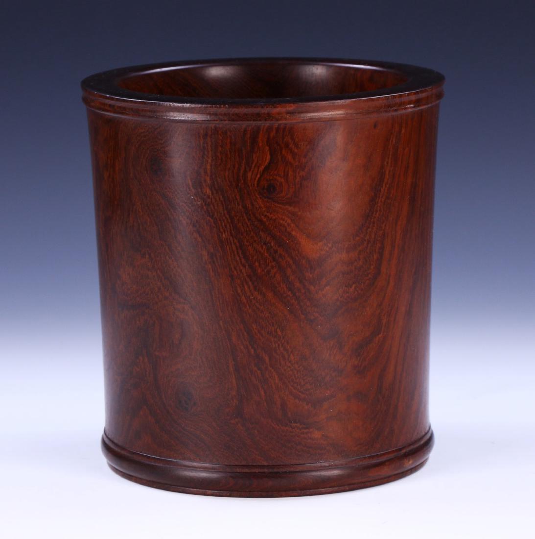 A CHINESE ANTIQUE WOOD CARVED BRUSHPOT: A Chinese Antique Wood Carved Brushpot: Of Cylindrical Form, The Wood Of A Rich Medium To Dark Brown Tone; Size: H: 7-1/2" (19.05cm); D: 7" (17.78cm)