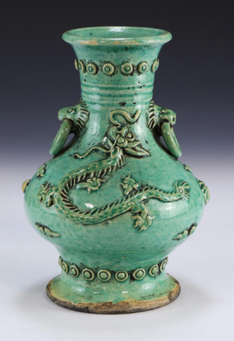 A Chinese Antique Celadon Glazed Porcelain Vase: A Chinese Antique Celadon Glazed Porcelain Vase: Of Compressed Globular Form Rising To A Cylindrical Neck And Slightly Flared Rim, The Shoulder With Two Lion Masks Handles Holding Molded Rings, The Bo