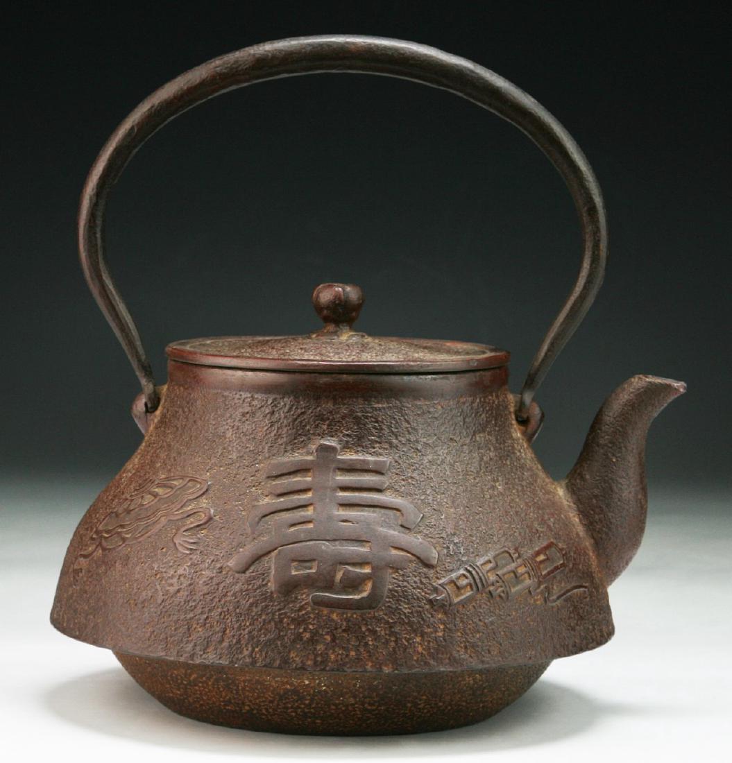 A JAPANESE ANTIQUE IRON TEAPOT: A Japanese Antique Iron Teapot; Size: H: 8-1/4" (20.96cm); L: 8" (20.32cm)