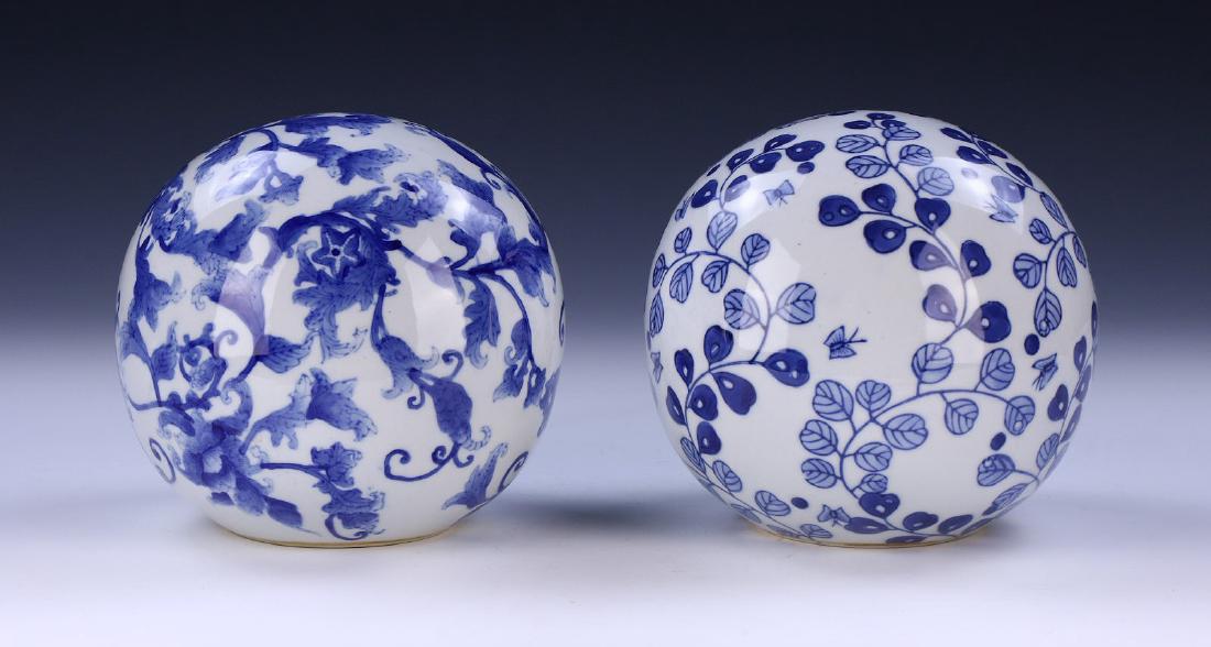 PAIR CHINESE ANTIQUE BLUE AND WHITE PORCELAIN BALLS: Pair Chinese Antique Blue And White Porcelain Balls: One With The Design Of Blooming Flowers Amid Scrolling Vines; Together With The Other With The Design Of Flying Butterflies Among Twisting Foliage,