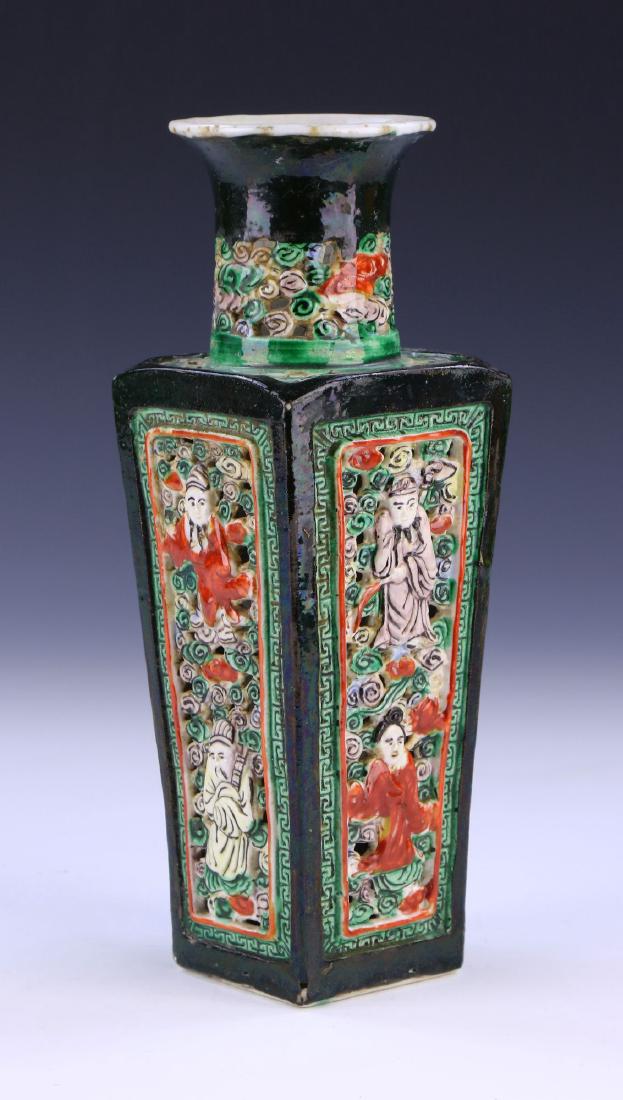 A CHINESE ANTIQUE FAMILLE VERTE PORCELAIN VASE: A Chinese Antique Famille Verte Porcelain Vase: Of Squared Shouldered Form Rising To A Cylindrical Neck And Outwardly Flared Rim, Each Side Of The Body Finely Molded With Two Figures Amid Swirling Pat