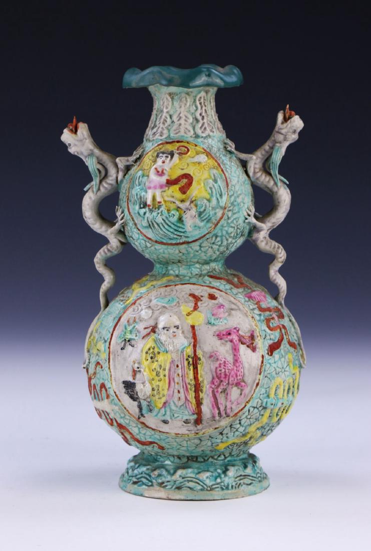 A CHINESE ANTIQUE FAMILLE ROSE PORCELAIN VASE: A Chinese Antique Famille Rose Porcelain Vase: Of Gourd Form, Bulbous Neck Flanked On Each Side By Chi Dragon Form Handles, Body Finely Painted With Four Celestial Being Figure Panels, Four Character