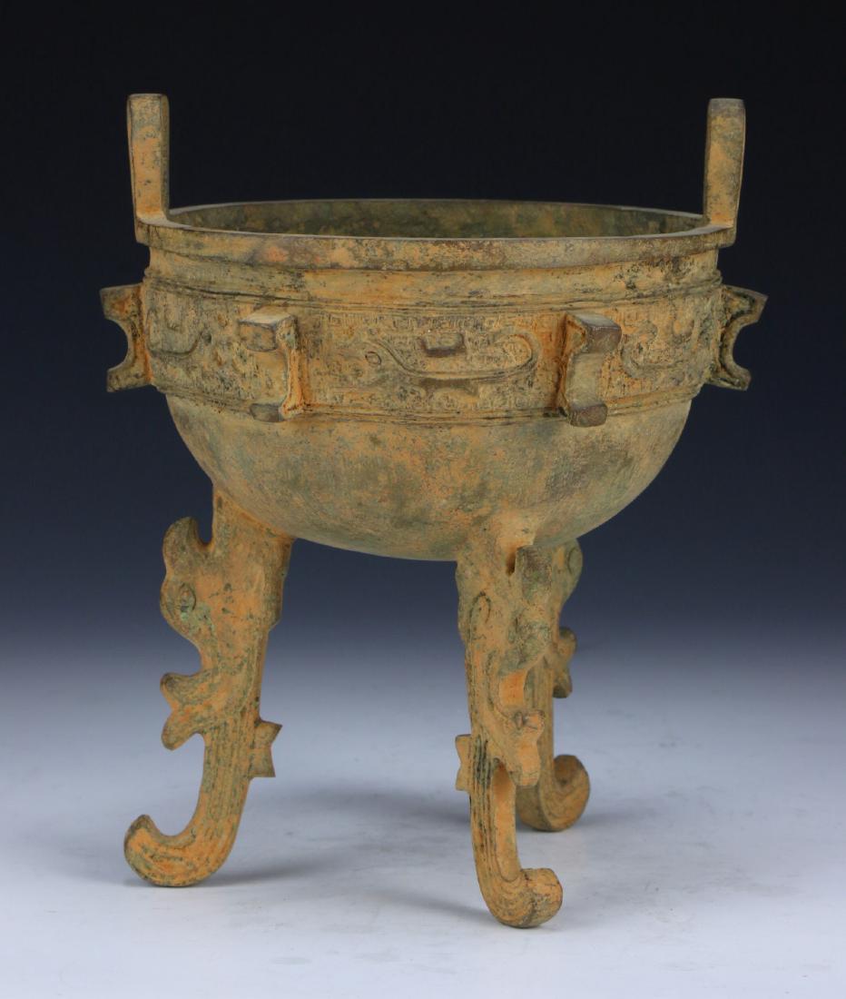 A CHINESE ANTIQUE BRONZE RITUAL TRIPOD CENSER (1 of 4)