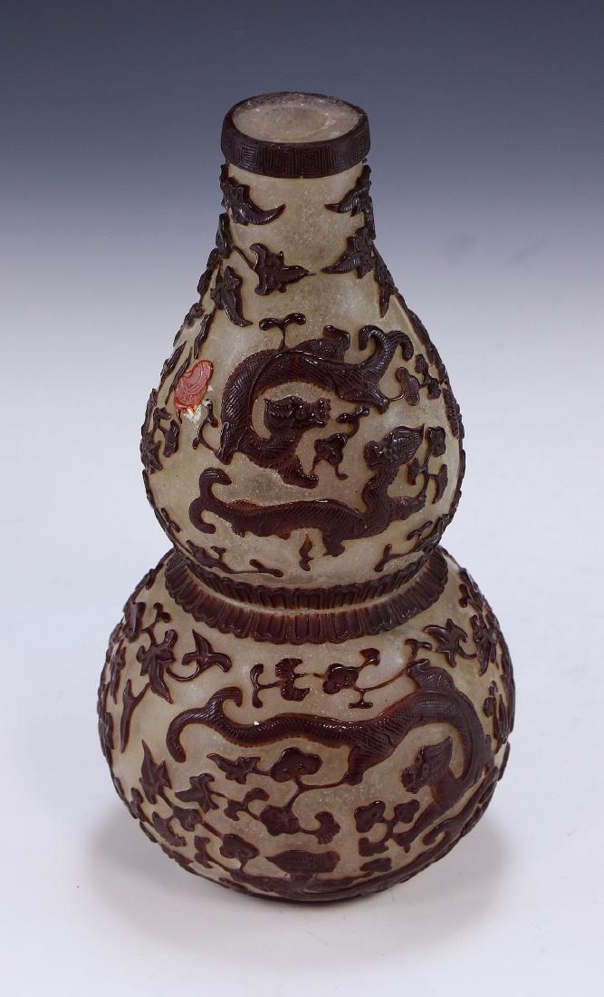 A CHINESE ANTIQUE PEKING GLASS GOURD VASE: 清雪花地套料刻葫蘆瓶A Chinese Antique Peking Glass Gourd Vase: Finely Carved With Red Dragons, Contrasting With The Off-White Vase Color, Ex