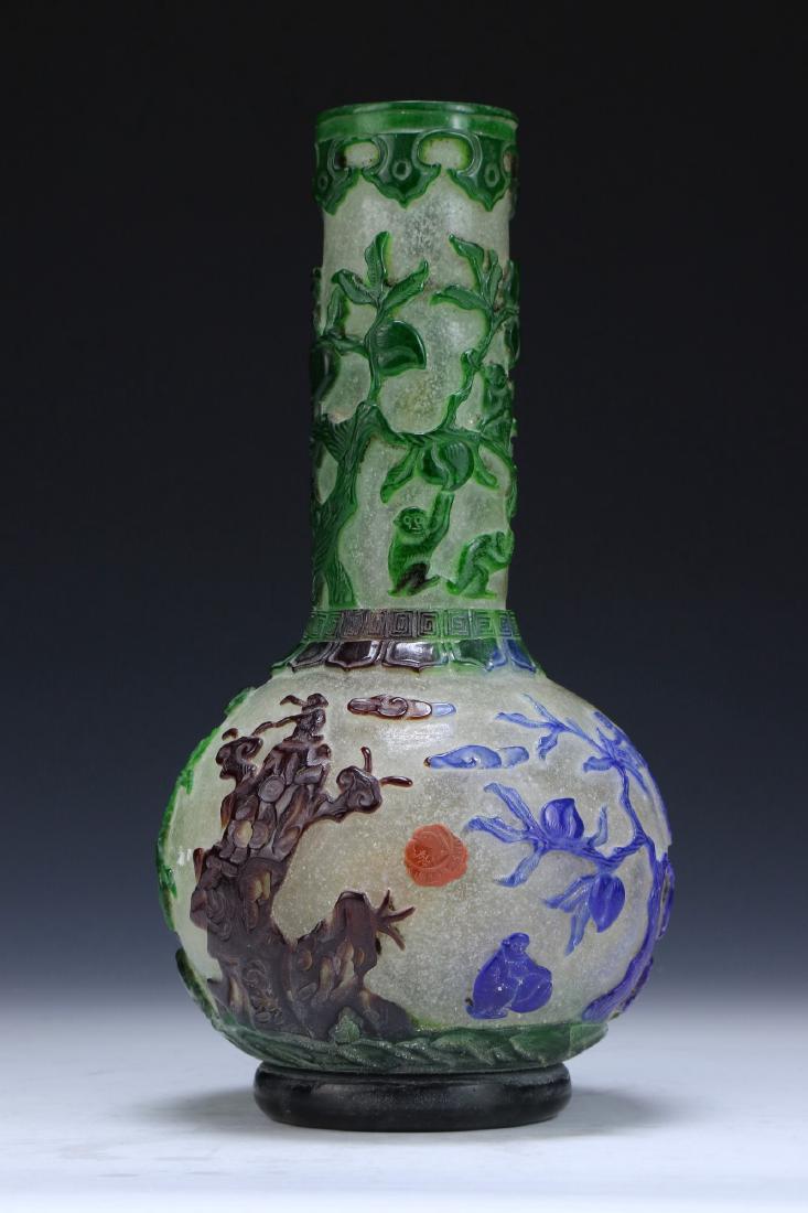 A CHINESE ANTIQUE PEKING GLASS VASE: A Chinese Antique Peking Glass Vase: Of Globular Form Rising To A Cylindrical Neck, Semi Translucent Glass Overlaid With Skillfully Carved Monkeys Amid Peach Branches, Four Character Mark On The Base