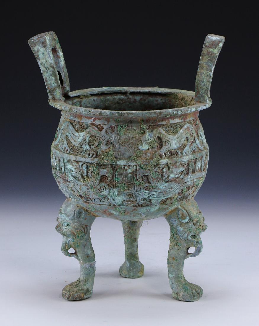 A CHINESE ARCHAIC BRONZE TRIPOD VESSEL DING (1 of 4)