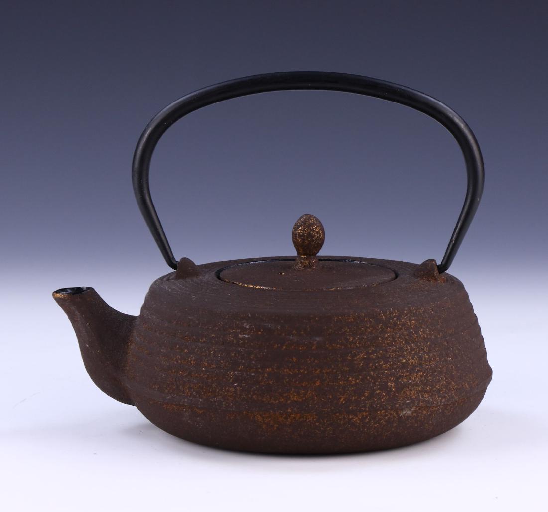A JAPANESE ANTIQUE IRON TEAPOT: A Japanese Antique Iron Teapot:; Size: L: 7-1/2" (19.05cm)