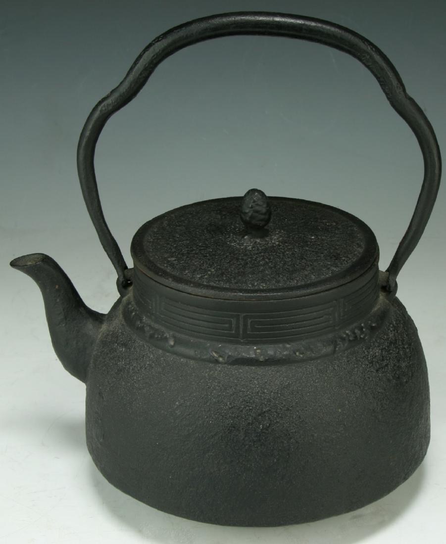 A JAPANESE ANTIQUE IRON TEAPOT: A Japanese Antique Iron Teapot With Cover: Of 19Th Century; Size: H: 10" (25.4cm); L: 8-1/4" (20.96cm)