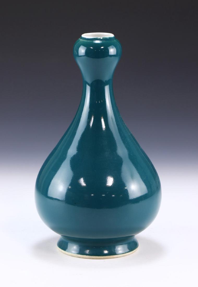 A CHINESE ANTIQUE BLUE GLAZED PORCELAIN VASE: A Chinese Antique Blue Glazed Porcelain Vase: Of Pear Form Rising To A Cylindrical Neck And Garlic Head Rim, The Body Evenly Coated in A Consistent Blue Glaze, Six Character xuande Mark On The Base in