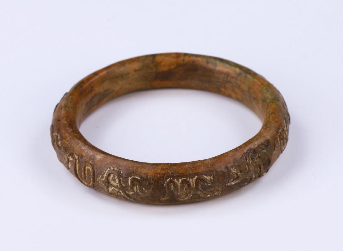 AN ARCHAIC JADE CARVED BANGLE (1 of 2)
