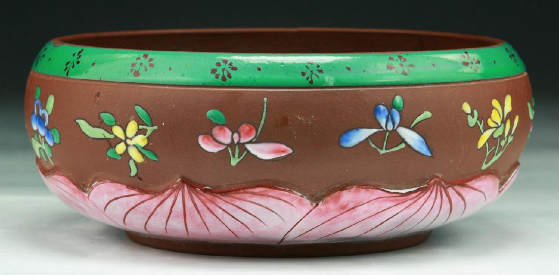 A CHINESE ANTIQUE POLYCHROME YIXING ZISHA BOWL: A Chinese Antique Polychrome Yixing Zisha Bowl: Finely Painted With Flowers Around The Exterior, Signed On The Base; Size: D: 7" (17.78cm)