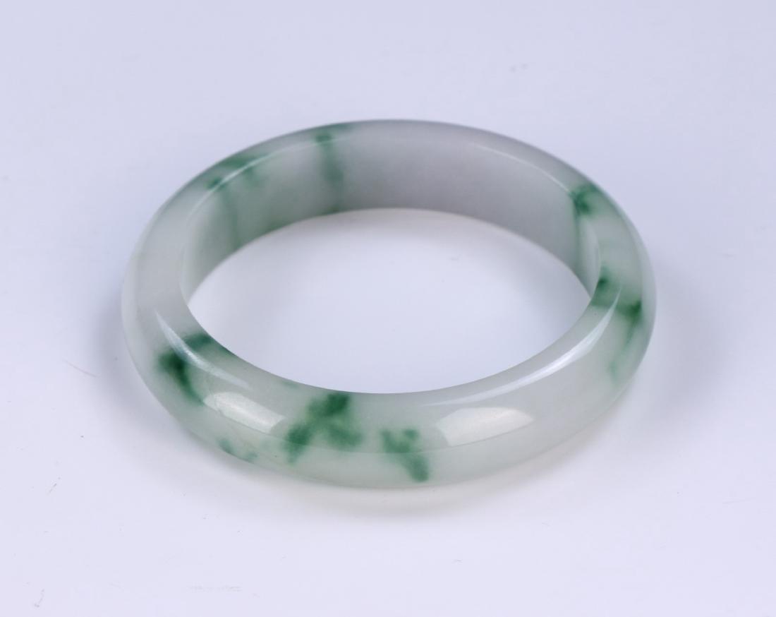 A JADEITE CARVED BANGLE (1 of 2)
