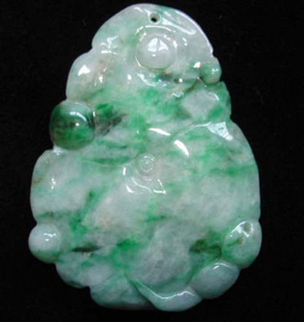 A Chinese Natural Jadeite Plaque ,Qing Dynasty: A Natural Jadeite Plaque withlotus leaf motif ,Qing Dynasty , size: 5 X 3.8 CM