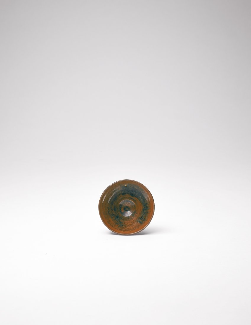 A JIAN HAREâ€™S FUR TEA BOWL: SONG DYNASTY (960-1279) This tea bowl is wide-mouthed, with a slight protrusion under the lip, a sloping belly that tapers off rapidly towards the bottom, a thin base, and a ring foot. The bowl is cov