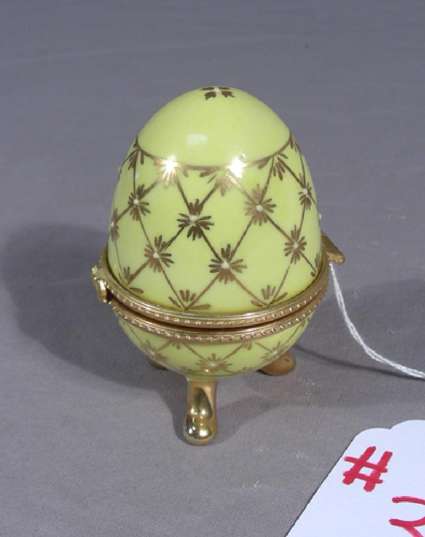 HAND PAINTED PORCELAIN AND METAL EGG: Clock inside of egg. 3 1/4" high.