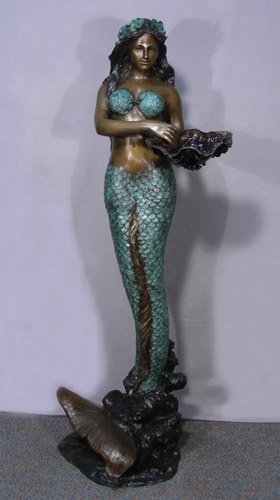 LIFE SIZE BRONZE SCULPTURE/FOUNTAIN "MERMAID": Mermaid emerges from a wave and holds a shell. Note: Water emerges from shell when used as a fountain. Very fine detail. Three color patina. 67 1/2" high.