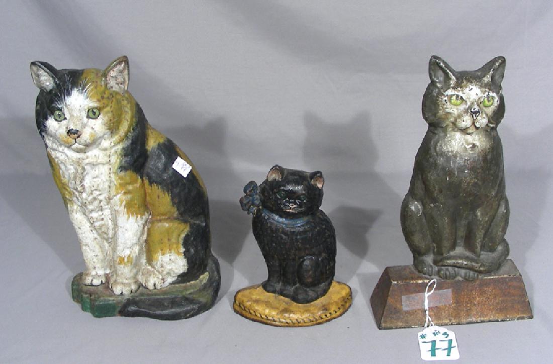 THREE ANTIQUE PAINTED CAST IRON DOOR STOPS (1 of 2)