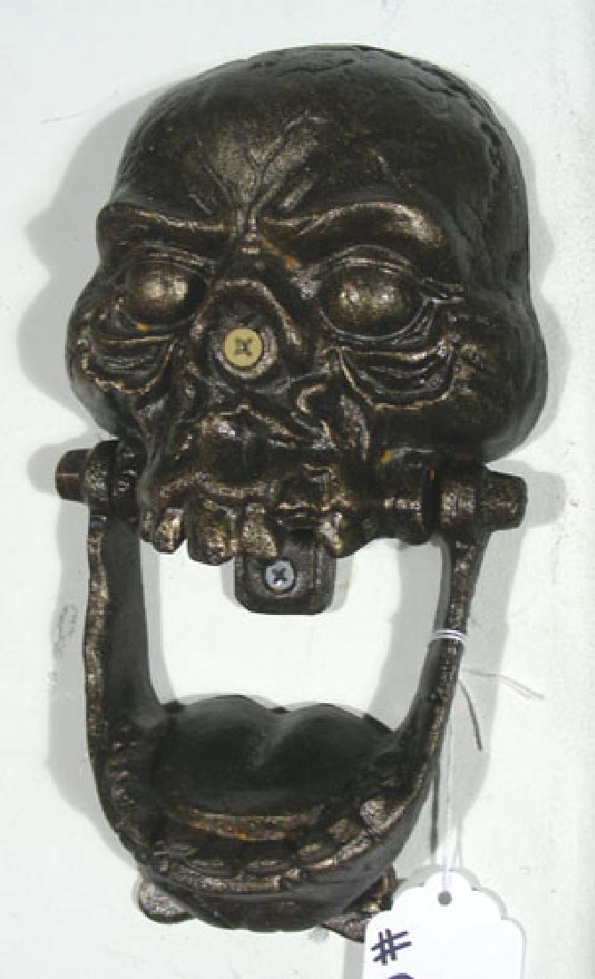 UNUSUAL HEAVY CAST IRON SKULL DOOR KNOCKER: Bone shaped knocking plate. 10" high, 5 1/2" wide.