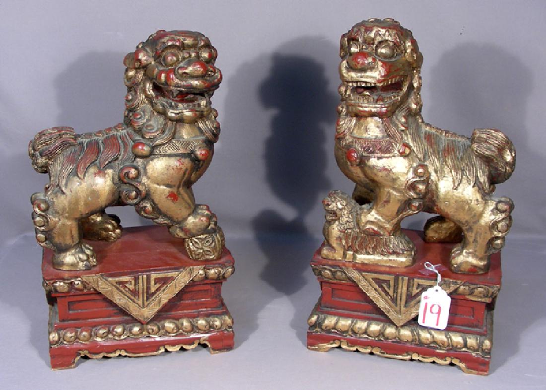 PAIR VINTAGE HAND CARVED CHINESE WOODEN FOO DOGS: Hand painted. 19" high, 12" wide.