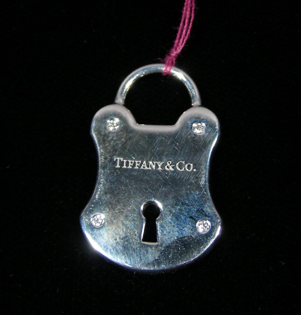 TIFFANY & CO. STERLING LOCKET: Signed "Tiffany & Co. on front & back. Original pouch and box included.