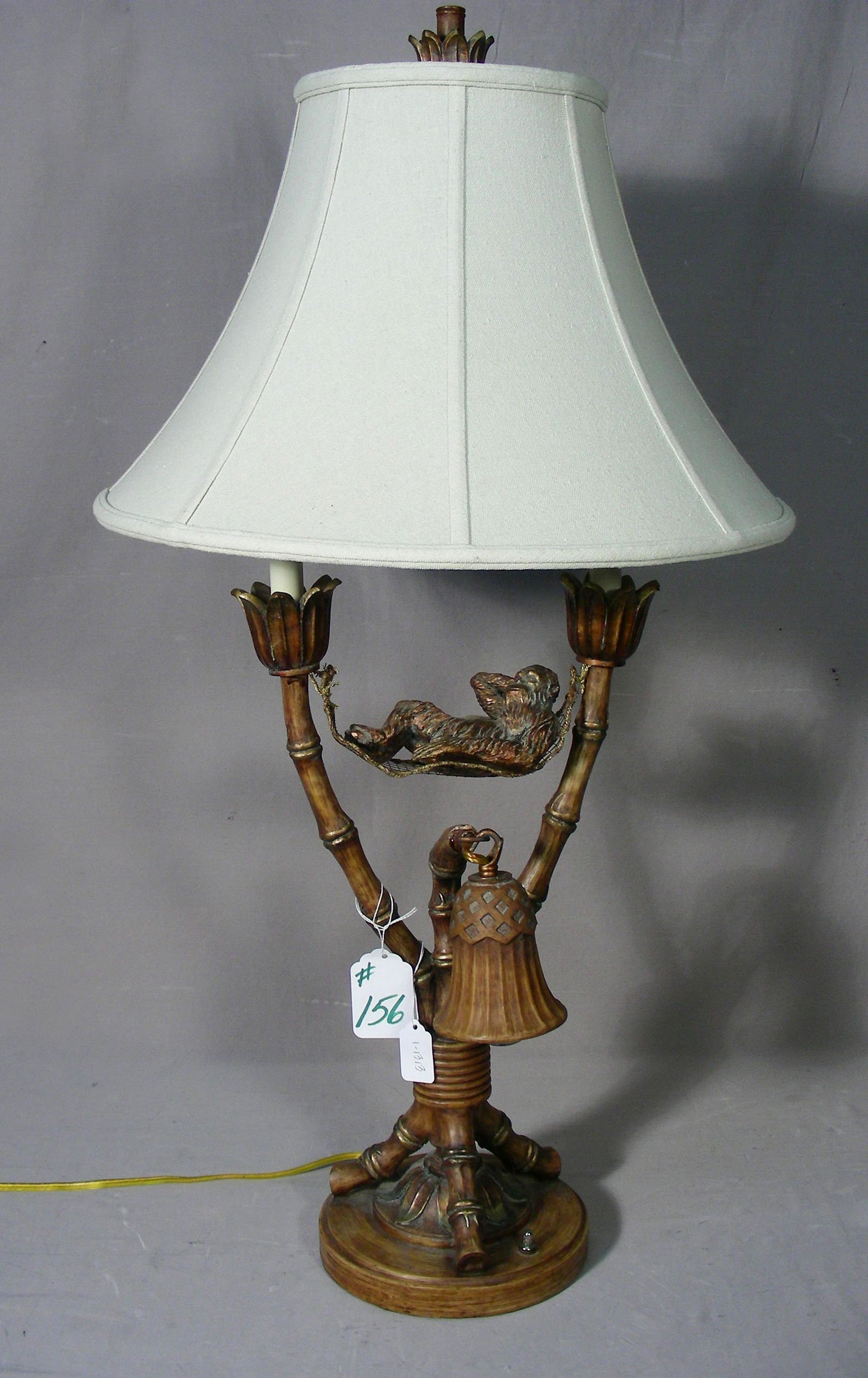 HEAVY HAND PAINTED COMPOSITION MONKEY TABLE LAMP: Humorous lamp with monkey lying in hammock. 34" high.
