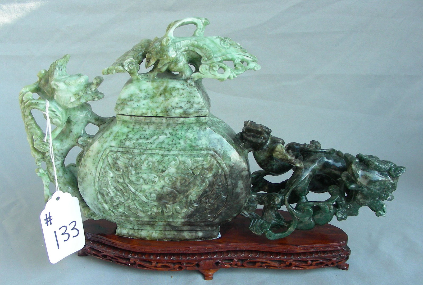VERY FINE VINTAGE HAND CARVED CHINESE JADE SCULPTURE: Urn with foo dog. Note: Some repair. Fitted stand. 9 1/2" high, 14" wide.