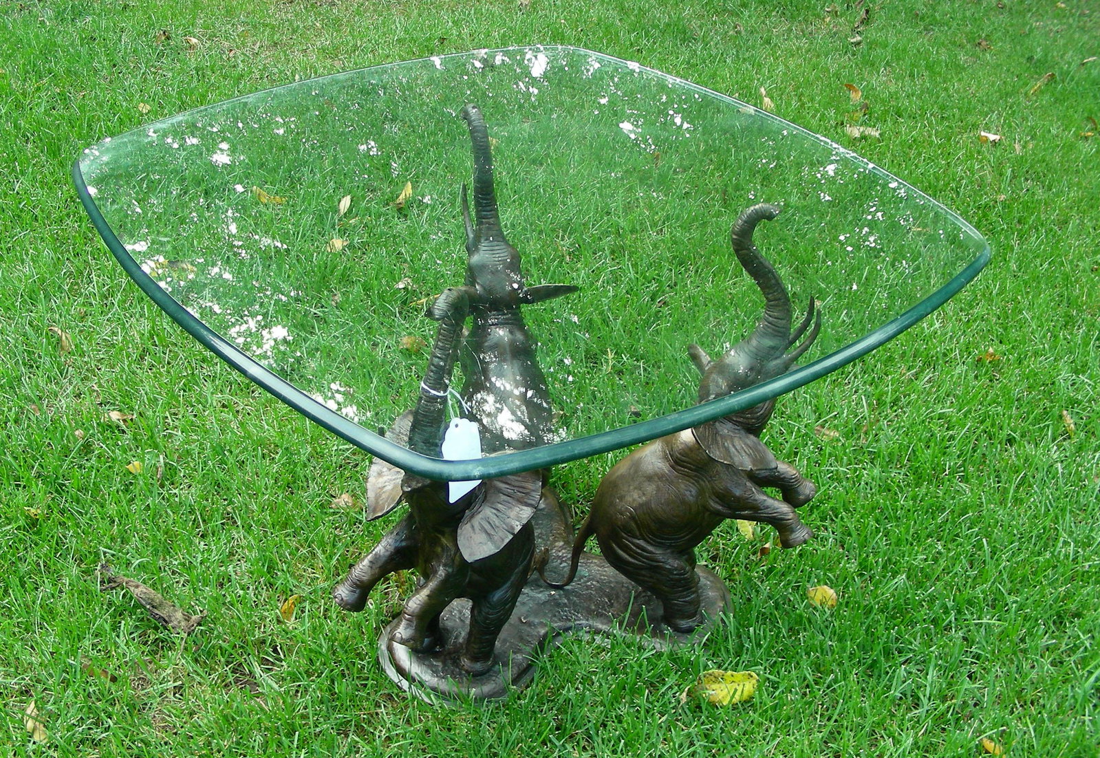 HEAVY BRONZE TRIPLE ELEPHANT TABLE BASE WITH GLASS TOP: Three elephants with upraised trunks. Brown patina. 18 1/2" high.