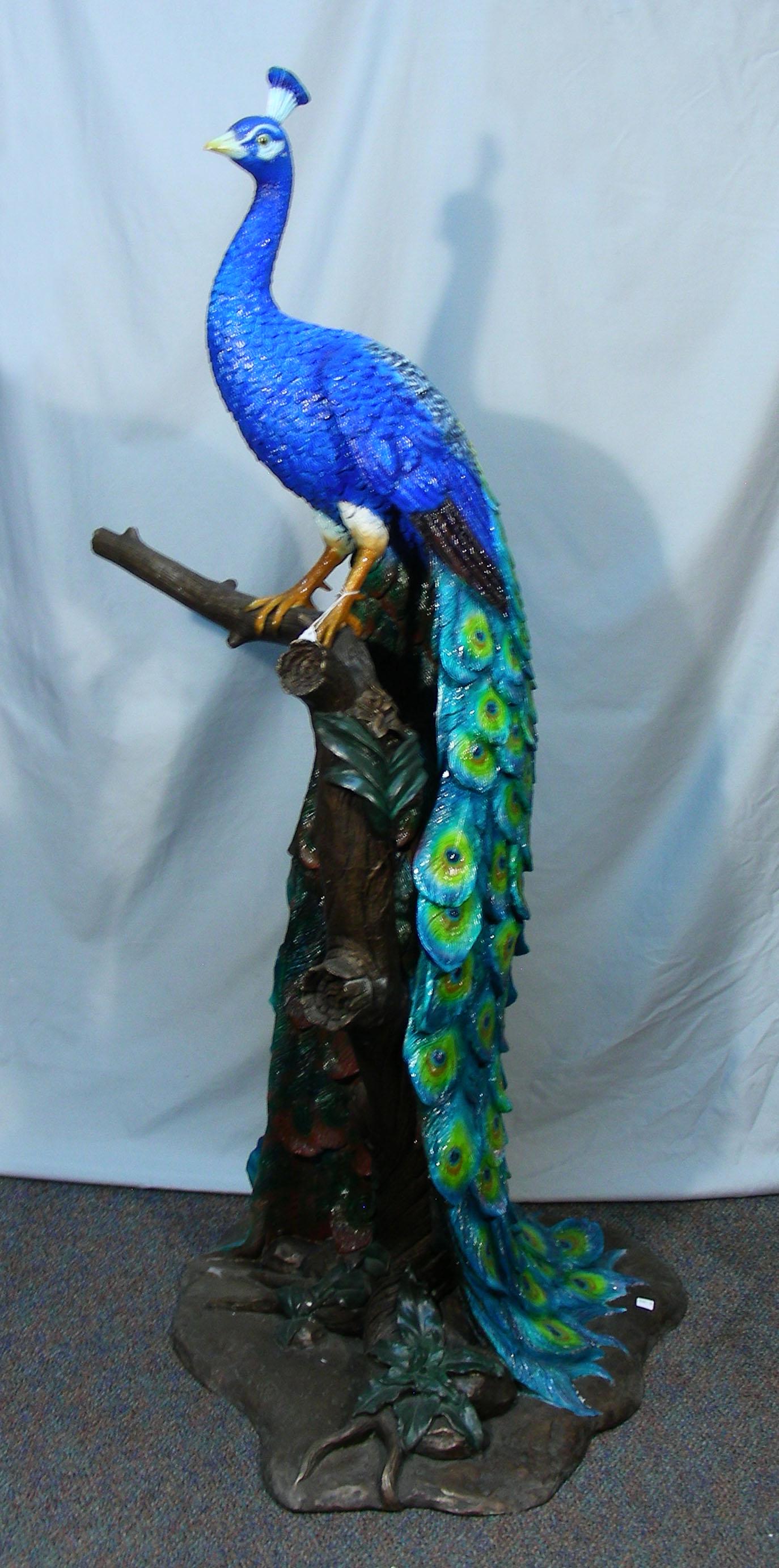 OUTSTANDING LIFE SIZE BRONZE SCULPTURE OF PEACOCK: Multi colored patina. Peacock is perched on a branch. Very fine detail. Signed on base. 63" high.