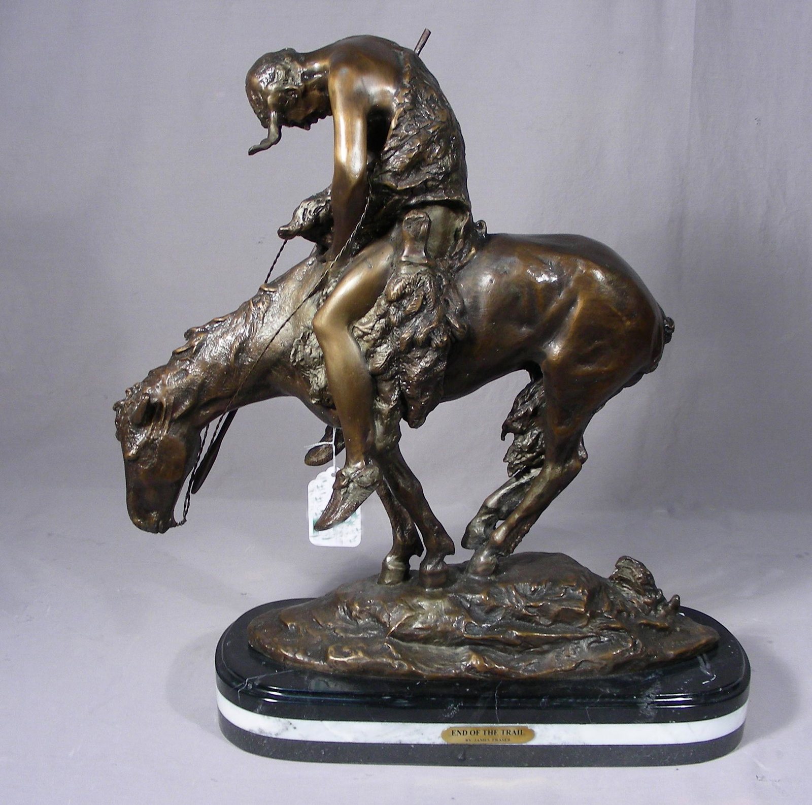BRONZE SCULPTURE "END OF THE TRAIL" AFTER JAMES EARLE: Very fine detail. Brown patina. Signed. Black & white marble base. 22" high, 20 1/2" long.
