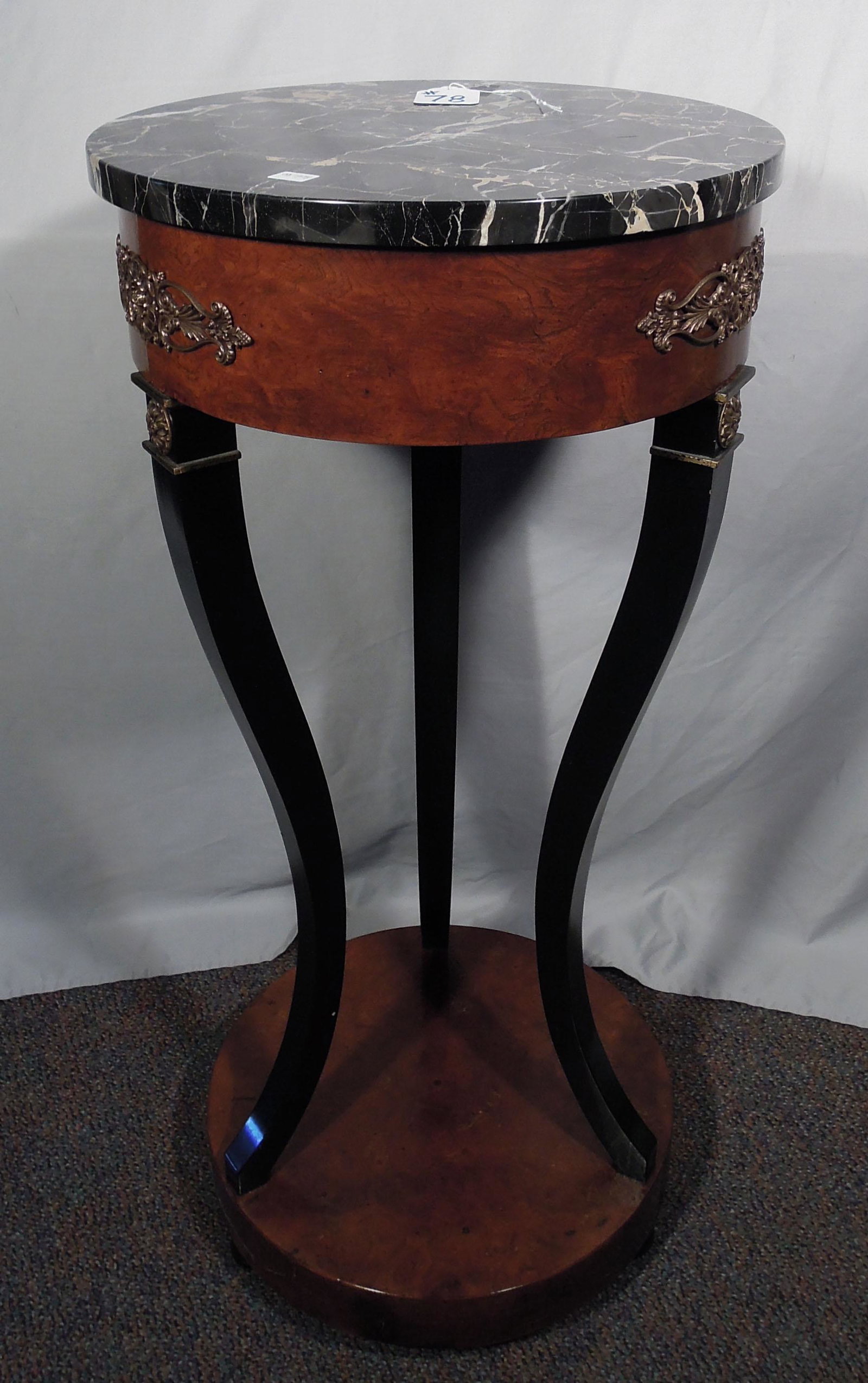 BEAUTIFUL HAND CARVED BURLWOOD PEDESTAL TABLE WITH: Three curved legs support a round top with black & brown marble top. Table finished with ormolu decorations. 34" high, 16" dia.