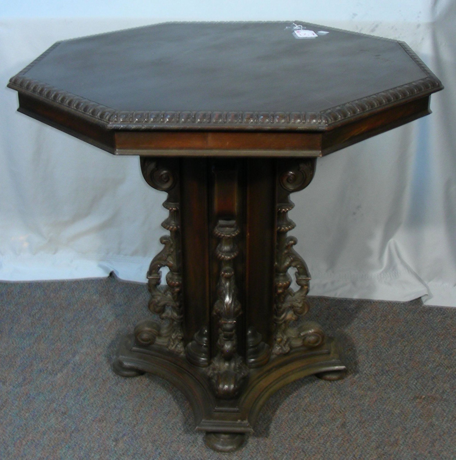 HAND CARVED ANTIQUE OCTAGONAL TABLE: Very ornate base and ribbed edge. 29 1/2" high, 29 1/2" dia.