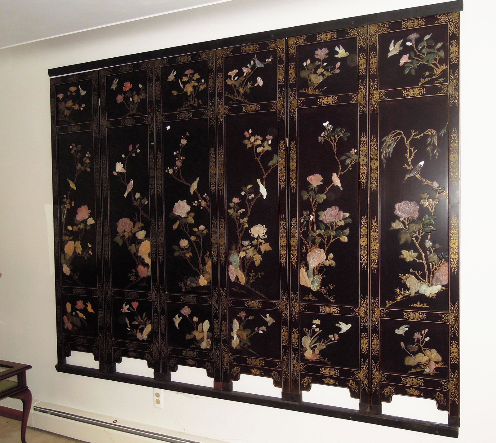 VINTAGE CHINESE BLACK LACQUOR AND HARDSTONE SIX PANEL: Each screen with hardstone flowers and birds. Each panel 6' high, 16" wide. Screen is complete with top and bottom wall brackets to hold entire screen.