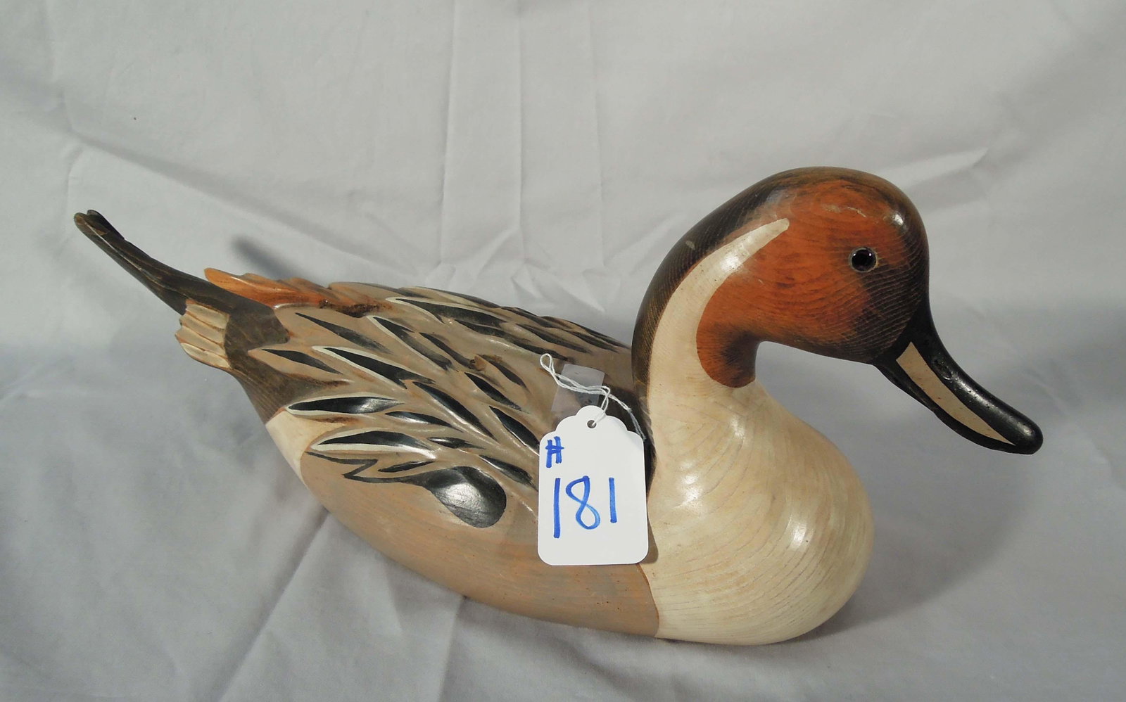 HAND CARVED WOODEN DUCK DECOY: Signed on base "Bob Hayden" with a gold medallion reading: Windy Creek 1990-1991. 8" high, 21" long.