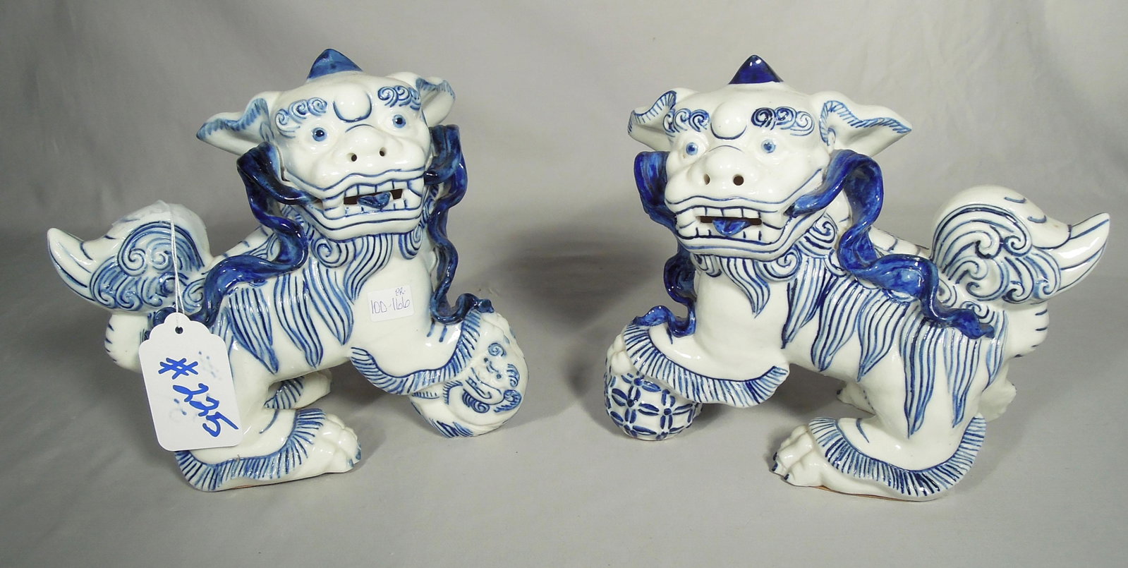 PAIR BLUE & WHITE CHINESE PORCELAIN FOO DOGS: 8" high, 8 1/2" wide.