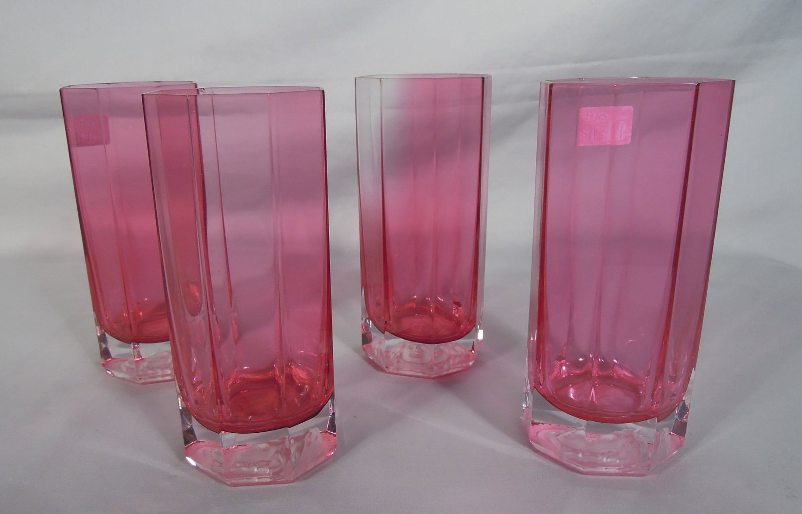 FOUR ROSENTHAL VERSACE LONG DRINK GLASSES: Rose colored. All signed. One with minor flea bite on rim.