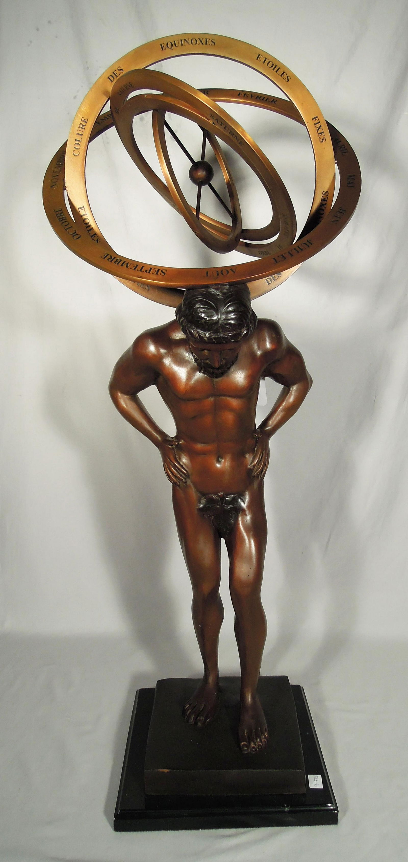 UNUSUAL BRONZE SCULPTURE OF SEMI NUDE ATLAS WITH: Standing semi nude Atlas with hands on hips and moving planets on shoulders. Black marble base. 35 1/2" high.