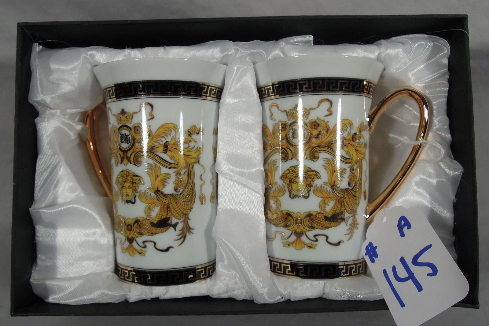 PAIR VERSACE STYLE COFFEE MUGS: Medusa and Greek key design. White ground. In original box.