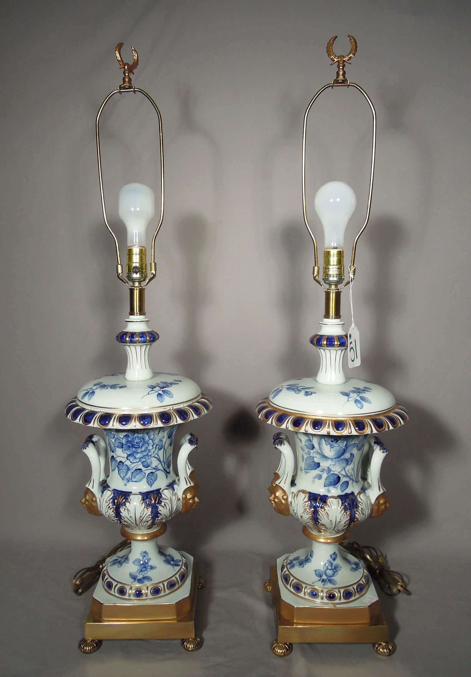 PAIR DESIGNER FREDERICK COOPER BLUE & WHITE PORCELAIN: Gold painted faces and brass base. 38" high.